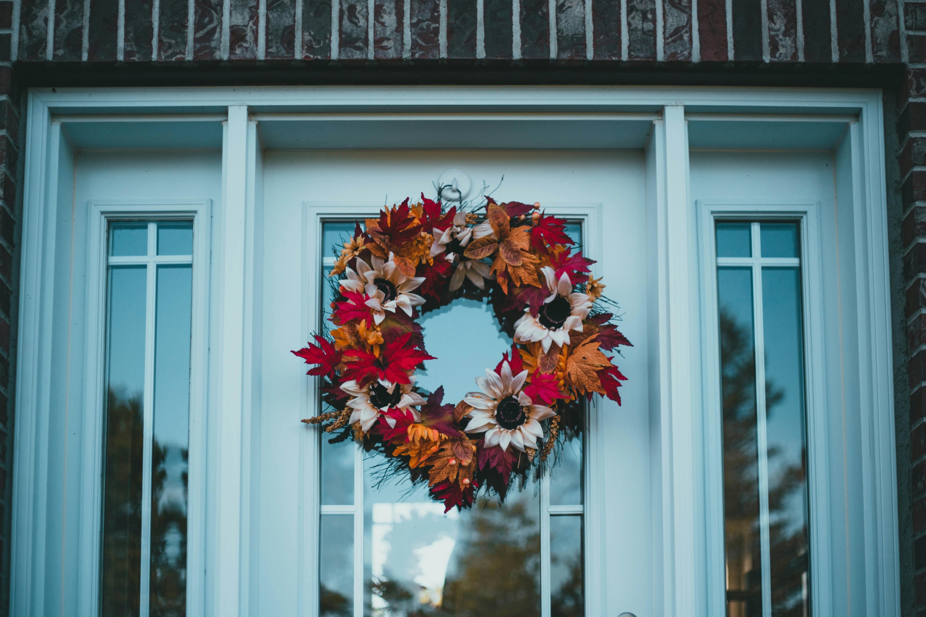 Autumn wreath of leaves and flowers on a door