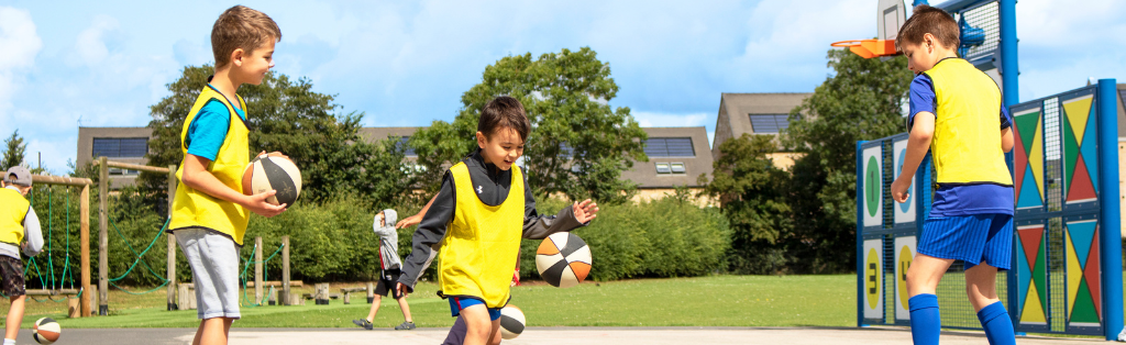 Children playing basketball at a Summer Holiday Camp 1